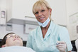 A female dental nurse/hygienist with a young boy patient