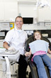 Photo: A male dentist with a young girl patient A male dentist with a young girl patient