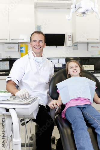 Photo: A male dentist with a young girl patient A male dentist with a young girl patient