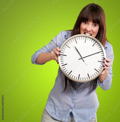 Photo: A Young Girl Holding A Clock And Angry A Young Girl Holding A Clock And Angry