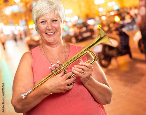 Photo: Senior Woman Blowing Her Trumpet Senior Woman Blowing Her Trumpet