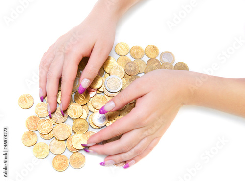 Photo: Heap of gold coins and a hand. Heap of gold coins and a hand.
