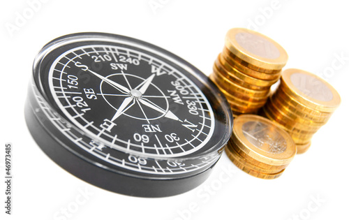 Photo: Compasses and columns of gold coins. Compasses and columns of gold coins.