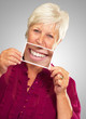 Photo: Senior Woman With Manifying Glass Showing Teeth Senior Woman With Manifying Glass Showing Teeth