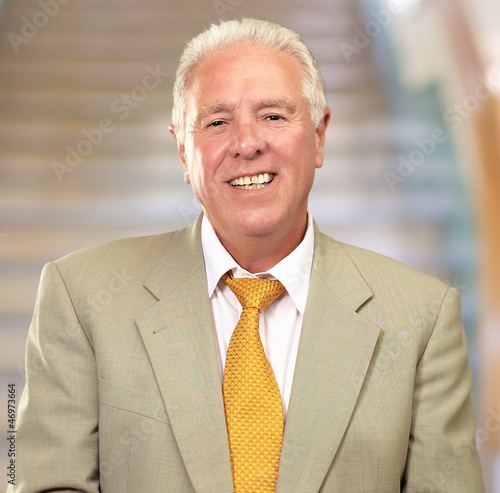 Photo: Portrait Of A Senior Man Holding A Laptop Portrait Of A Senior Man Holding A Laptop