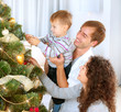 Young Family decorating a Christmas Tree