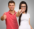 Portrait Of Happy Young Couple Gesturing
