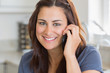 Photo: Brunette woman calling in the kitchen Brunette woman calling in the kitchen