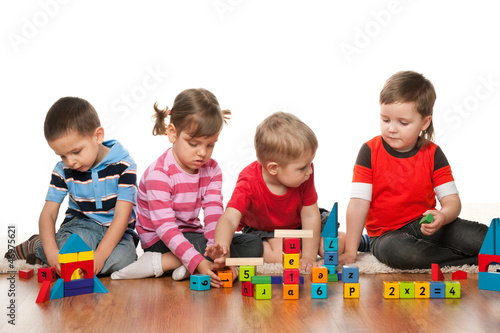 Photo: Four children are playing on the floor Four children are playing on the floor