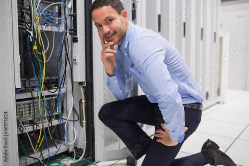 Photo: Smiling man checking the servers Smiling man checking the servers