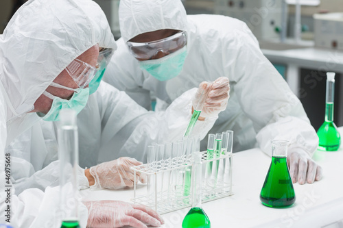 Photo: Two chemists experimenting with the green liquid Two chemists experimenting with the green liquid