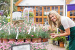 Smiling florist looking at clay pots
