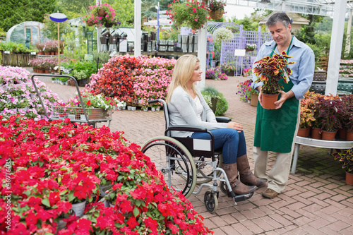 Photo: Woman in wheelchair buying a plant Woman in wheelchair buying a plant