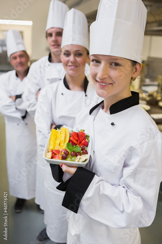 Photo: Smiling chef holding fruit plate Smiling chef holding fruit plate