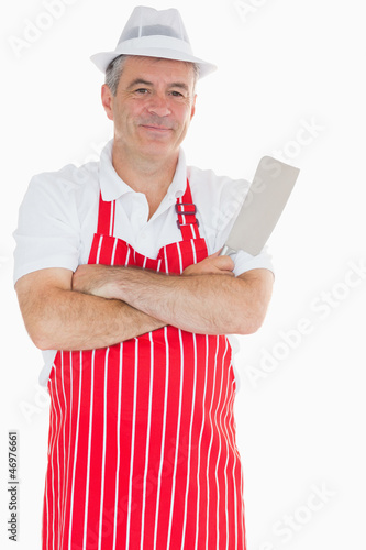 Photo: Butcher with arms crossed holding meat cleaver Butcher with arms crossed holding meat cleaver