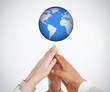 Foto: People reaching hands to globe People reaching hands to globe