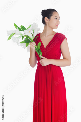 Photo: Woman in red dress holding lilies Woman in red dress holding lilies
