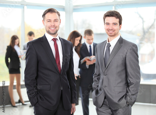 Photo: Two business men working together in the office Two business men working together in the office