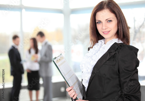 Photo: Face of beautiful woman on the background of business people Face of beautiful woman on the background of business people