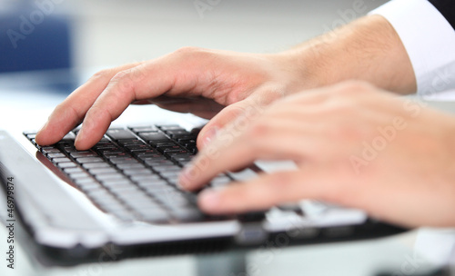 Photo: Close-up of typing male hands Close-up of typing male hands