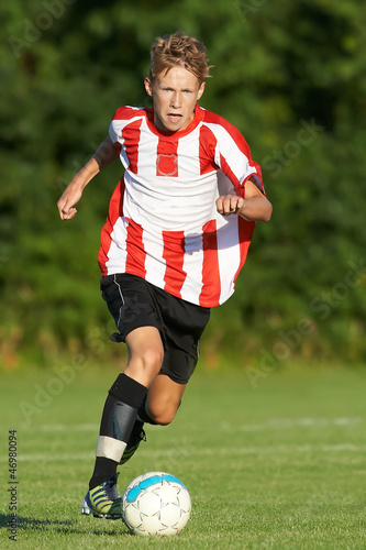 Photo: Young man playing soccer Young man playing soccer