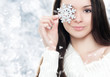Photo: Beautiful young woman with silver snowflake Beautiful young woman with silver snowflake