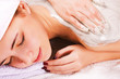 Young woman with slimming body thermal mask on her back. Spa Tre