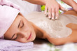 Young woman with slimming body thermal mask on her back. Spa Tre