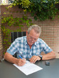 Senior signing a legal document