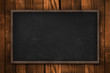 Blank blackboard on wooden wall