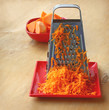 A grater and pieces of pumpkin