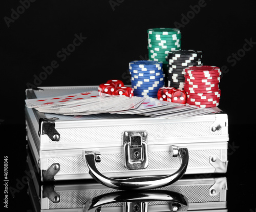 Photo: Poker set on a metallic case isolated on black background Poker set on a metallic case isolated on black background