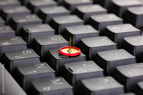 Photo: Painful typing, pin on keyboard close-up Painful typing, pin on keyboard close-up