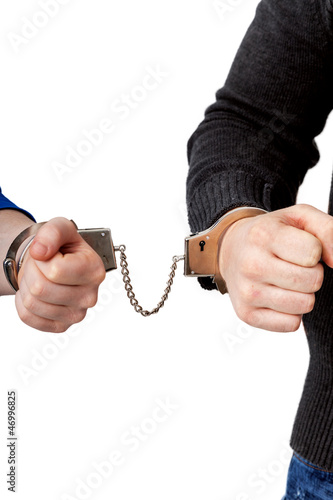 Photo: Men and women connected with handcuffs Men and women connected with handcuffs