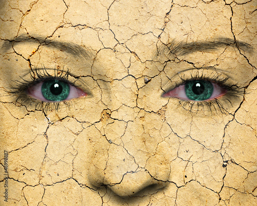 Photo: Woman face covered with old cracked red paint Woman face covered with old cracked red paint