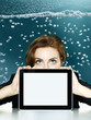 Woman looking over her tablet pc in the water