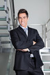 Happy Businessman Standing On Stairs