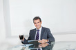 Businessman With Coffee Cup Using Digital Tablet In Office