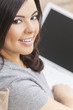 Happy Hispanic Woman Using Laptop Computer