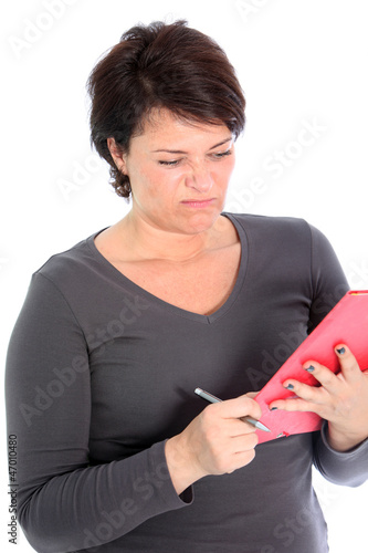 Photo: Woman grimacing at what she is reading Woman grimacing at what she is reading