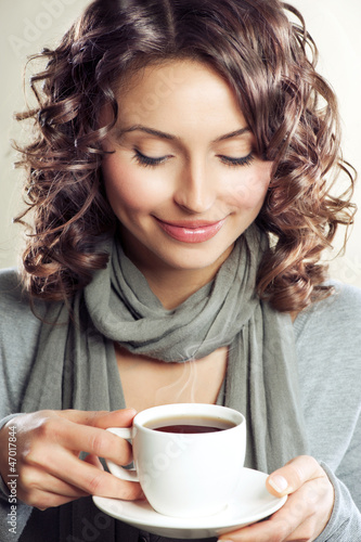 Photo: Beautiful Woman drinking Coffee or Tea Beautiful Woman drinking Coffee or Tea