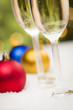 Christmas Ornaments and Champagne Glasses on Snow