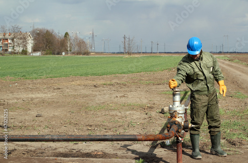 Photo: oil worker open pipeline valve oil worker open pipeline valve