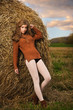 Beautiful woman near a haystack