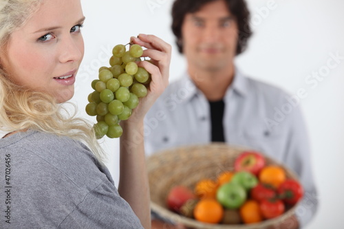 Photo: Couple stood with fruit basket Couple stood with fruit basket