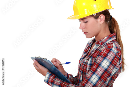 Photo: Tradeswoman filling in paperwork Tradeswoman filling in paperwork
