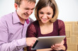Young smiling couple with digital tablet