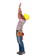 Laborer trying to touch the ceiling, studio shot
