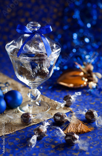 Photo: Christmas chocolate truffles in glass jar. Selective focus Christmas chocolate truffles in glass jar. Selective focus