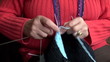grandmother hands knitting new ornamental sweater